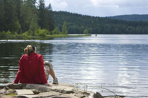 Peace and quiet. Lonely girl by a lake